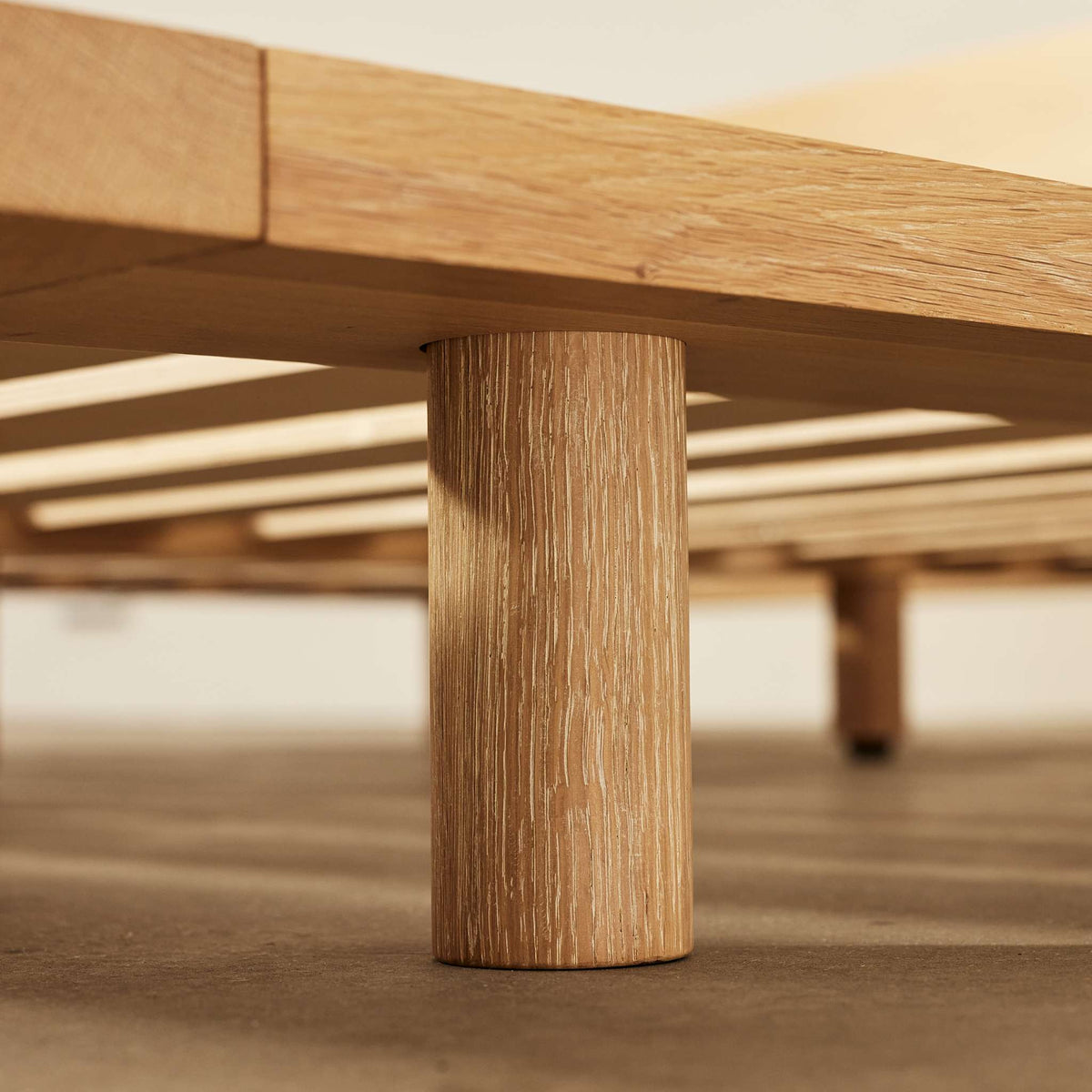 Close-up of Lagos timber bed frame leg, highlighting solid oak grain and hand turned craftsmanship – Totem Road