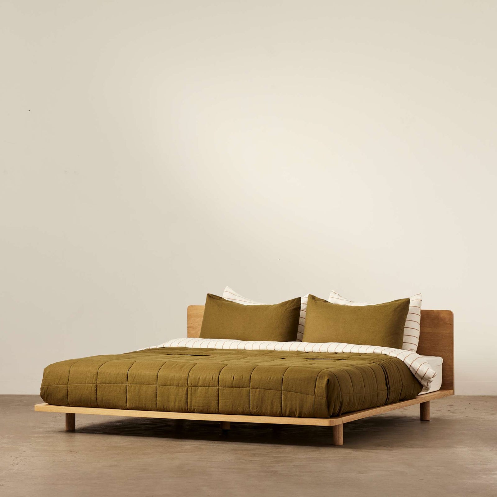 Lagos timber bed frame made from sustainably sourced solid oak, shown in a minimalist bedroom setting - Totem Road