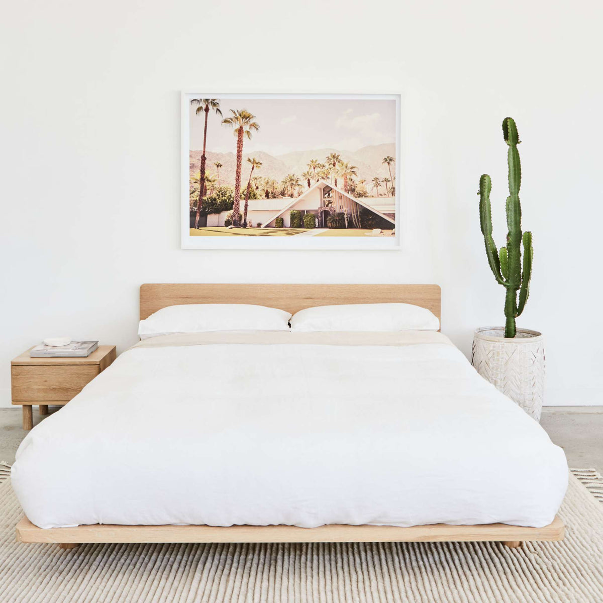 Lagos timber bed frame in solid oak, styled with white bedding and minimalist decor in a light-filled bedroom - Totem Road